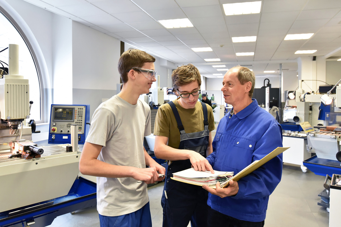 Group of young people in technical vocational training with teacher